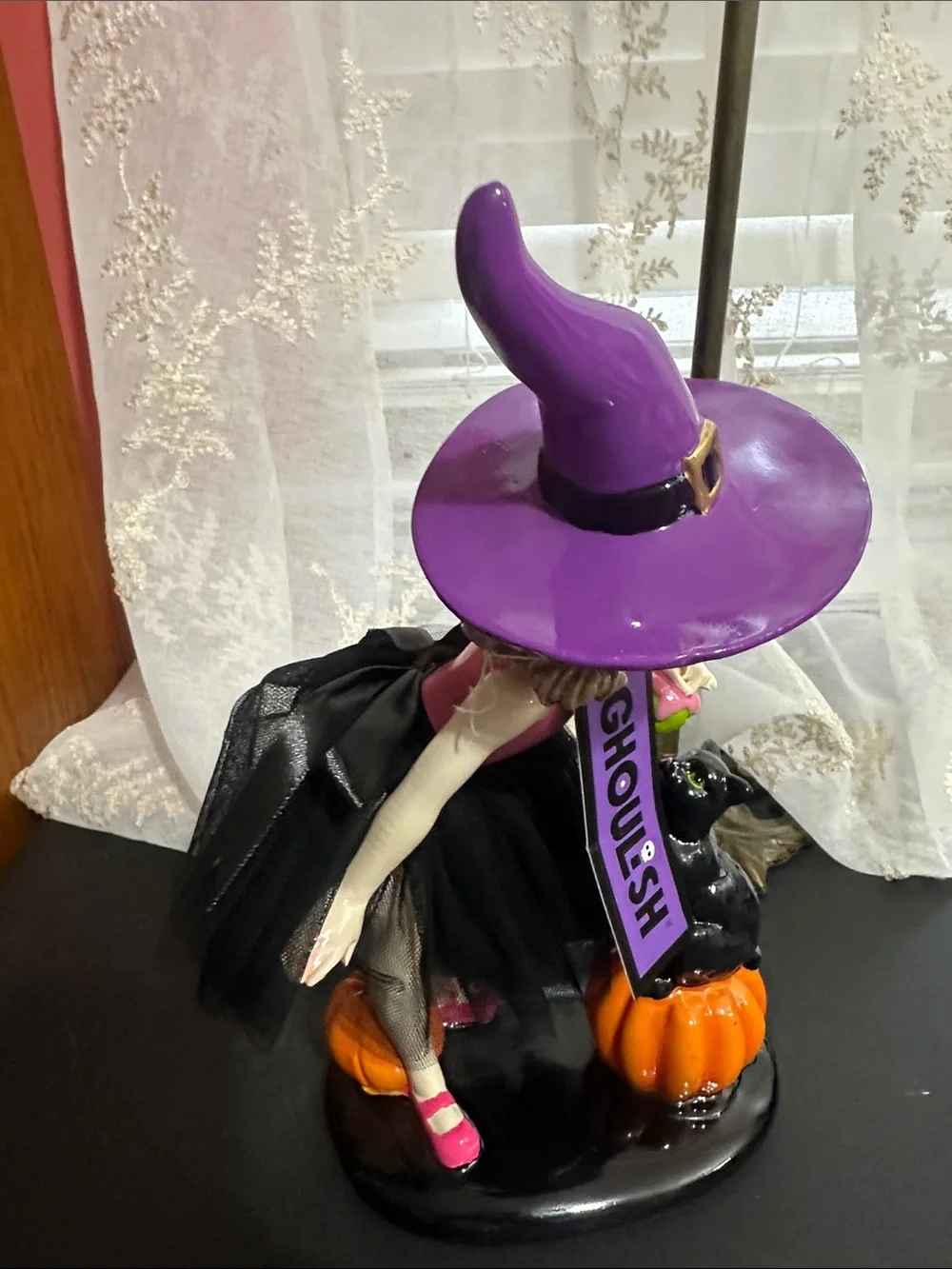 Ghoulish Halloween little girl with black cat decor